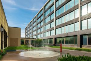 an office building with a fountain in front of it at Holiday Inn and Suites Charleston West, an IHG Hotel in Charleston