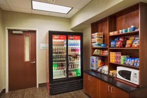 a room with a refrigerator with food in it at Holiday Inn Grand Rapids-Airport, an IHG Hotel in Grand Rapids