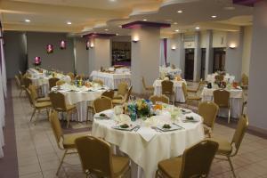 a banquet hall with white tables and chairs at Hotel Przedwiośnie in Masłów +35 photos