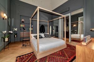 a bedroom with a canopy bed in a room at Luxury apartment in the center of Catania in Catania