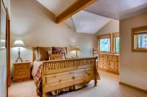 a bedroom with a wooden bed and a window at Foxglove Condos in Park City