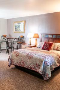 a bedroom with a bed and a table with chairs at Circle R Motel in East Glacier Park