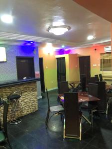 a restaurant with tables and chairs and a bar at DE’ BAKERS SUITES in Lagos