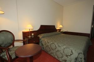 Uma cama ou camas num quarto em Hotel Apollonia Delphi