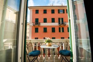 a balcony with a table and chairs and a building at Xenia in Genova