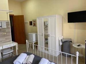 a bedroom with a bed and a large white cabinet at La Torre B&B in Avellino