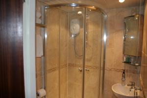 a bathroom with a shower and a sink at Royal Hotel in Girvan