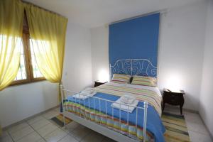 A bed or beds in a room at La Casa del Gelso Fiorito