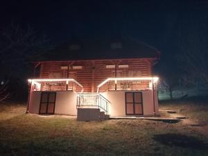 a building with lights on the side of it at night at Apartmani Žuti Leptir in Vrdnik