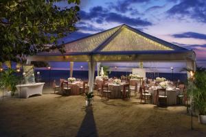 a wedding reception in a pavilion with tables and chairs at Couples Swept Away in Negril