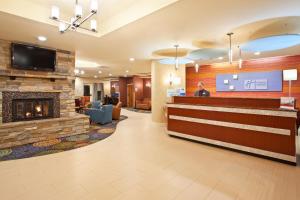 a lobby of a hotel with a fireplace at Holiday Inn Express Hotel & Suites Pittsburgh Airport, an IHG Hotel in Robinson Township