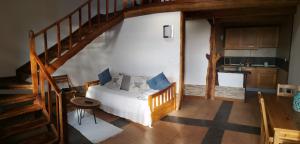 a bedroom with a bed and a staircase with a kitchen at Hotel os Moinhos in Velas