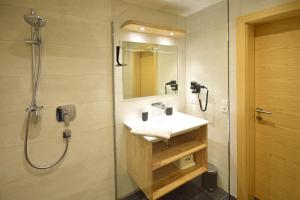 a bathroom with a sink and a shower at Waidmannsruh Appartements in Gerlos