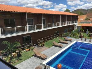 een resort met een zwembad en een gebouw bij HOTEL VIRGULINO in Olho D’Água do Casado