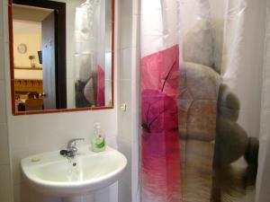 a bathroom with a sink and a shower curtain at Patio Granada in Granada