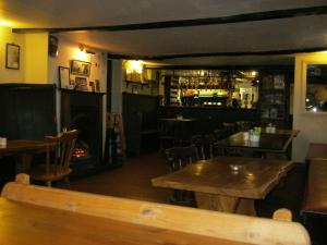 a restaurant with tables and chairs and a bar at The Ship Inn in Blaxhall