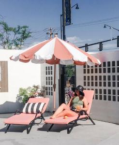 a person sitting on a bench under an umbrella at RSVP Hotel in Bozeman
