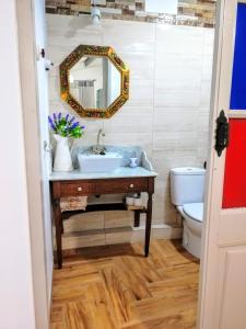 a bathroom with a sink and a mirror and a toilet at ATICO Loli in Berga +14 photos