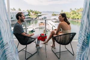 パシフィック・ハーバーにあるThe Pearl South Pacific Resort, Spa & Golf Courseのバルコニーの椅子に座る男女 +37枚の写真