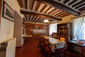 a kitchen with a table and chairs in a room at Castelvecchio Alto in Castelvecchio