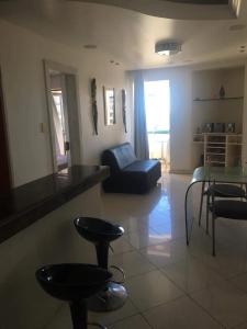 a living room with a couch and a chair at Ondina Atlantic City in Salvador