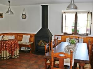a dining room with a fireplace and a table and chairs at Casa Rural Nevada in Horcadas