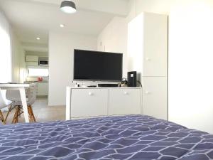 a bedroom with a bed and a flat screen tv at Independencia 1302 10A by HB in Buenos Aires