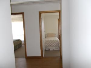 a bedroom with a mirror and a bed at Costa Plenti Southend BnB in Southend