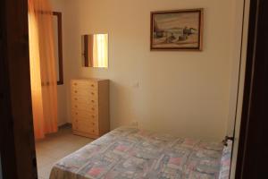 a bedroom with a bed and a picture on the wall at Casa Matilde in Capoliveri