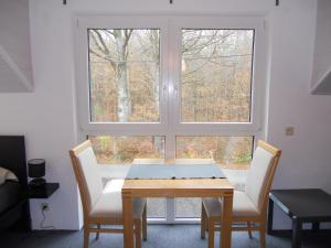 a table and two chairs in front of a window at B&B V.K. PGmbH in Saint-Vith