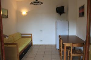 a living room with a couch and a table at Casa Matilde in Capoliveri