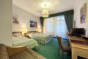 En eller flere senge i et værelse på Hotel Salvator