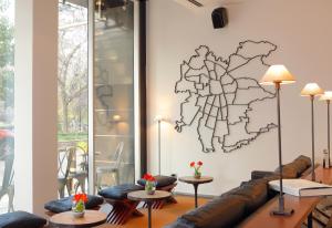 a living room with a couch and a map on the wall at Hotel Ismael in Santiago