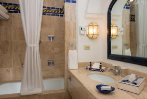 a bathroom with a sink and a tub and a mirror at Pueblo Bonito Los Cabos Blanco Beach Resort - All Inclusive in Cabo San Lucas