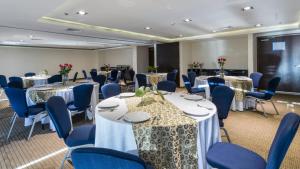 a conference room with tables and blue chairs at Holiday Inn Express Culiacan, an IHG Hotel in Culiacán