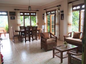 a living room with a table and chairs at Nisha homestay inn in Peradeniya