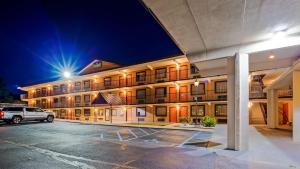 a hotel with a car parked in a parking lot at SureStay Hotel by Best Western Tupelo North in Tupelo