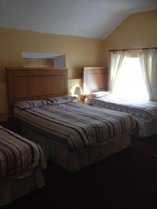 Łóżko lub łóżka w pokoju w obiekcie Glendine Inn