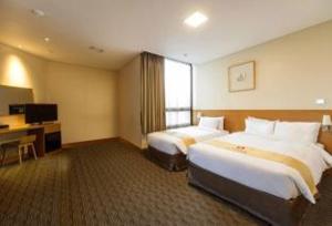 En eller flere senger på et rom på Hotel Skypark Central Myeongdong