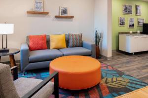 a living room with a couch and a table at Wood Spring Suites Washington DC East Arena Drive in Hyattsville