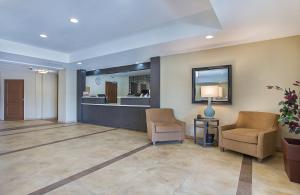a lobby with two chairs and a waiting room at Candlewood Suites Fort Campbell - Oak Grove by IHG in Oak Grove +26 photos
