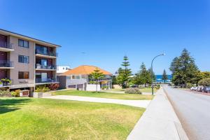a street view of a apartment complex with a park at Cottesloe Marine Apartment in Perth