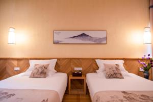 Postel nebo postele na pokoji v ubytování Floral Tengchong Mountain hotel