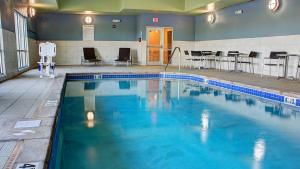 a swimming pool with blue water in a building at Holiday Inn Express Spencer, an IHG Hotel in Spencer
