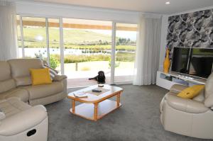 a living room with a couch and a coffee table at Cottage 45° South in Te Anau