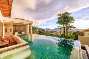 a swimming pool in a house with a view at Wyndham Sea Pearl Resort, Phuket in Patong Beach