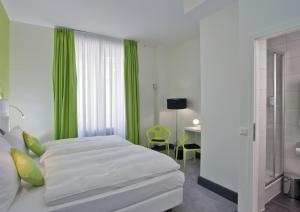 Кровать или кровати в номере Hotel City Inn Basel