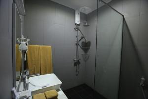 a bathroom with a shower and a white sink at Blue Sand Beach Resort in Trincomalee +92 photos