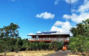 a house with solar panels on the side of a road at Coffee Garden in Captain Cook
