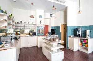 a kitchen with a sink, stove, cabinets and a refrigerator at Gozsdu Court Budapest in Budapest